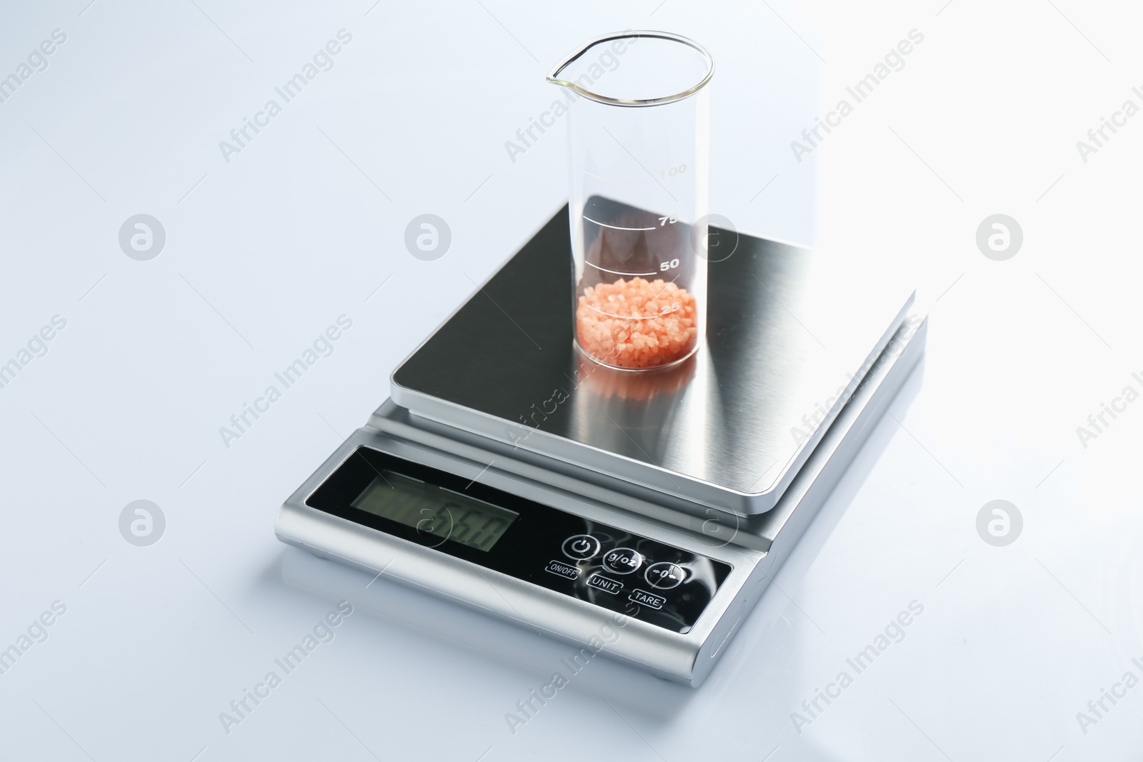Laboratory scale with beaker of sample on white background Photo of Laboratory scale with beaker of sample on white background