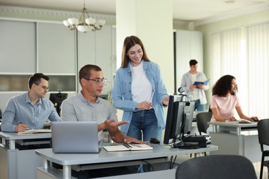 Photo of People studying together in library, selective focus