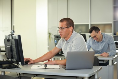 Photo of People studying at desks in library, selective focus