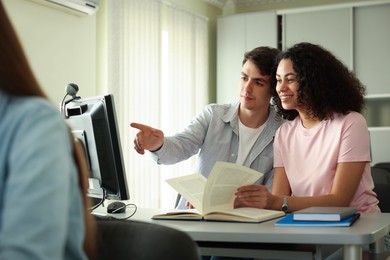 Photo of People studying together at desk in public library