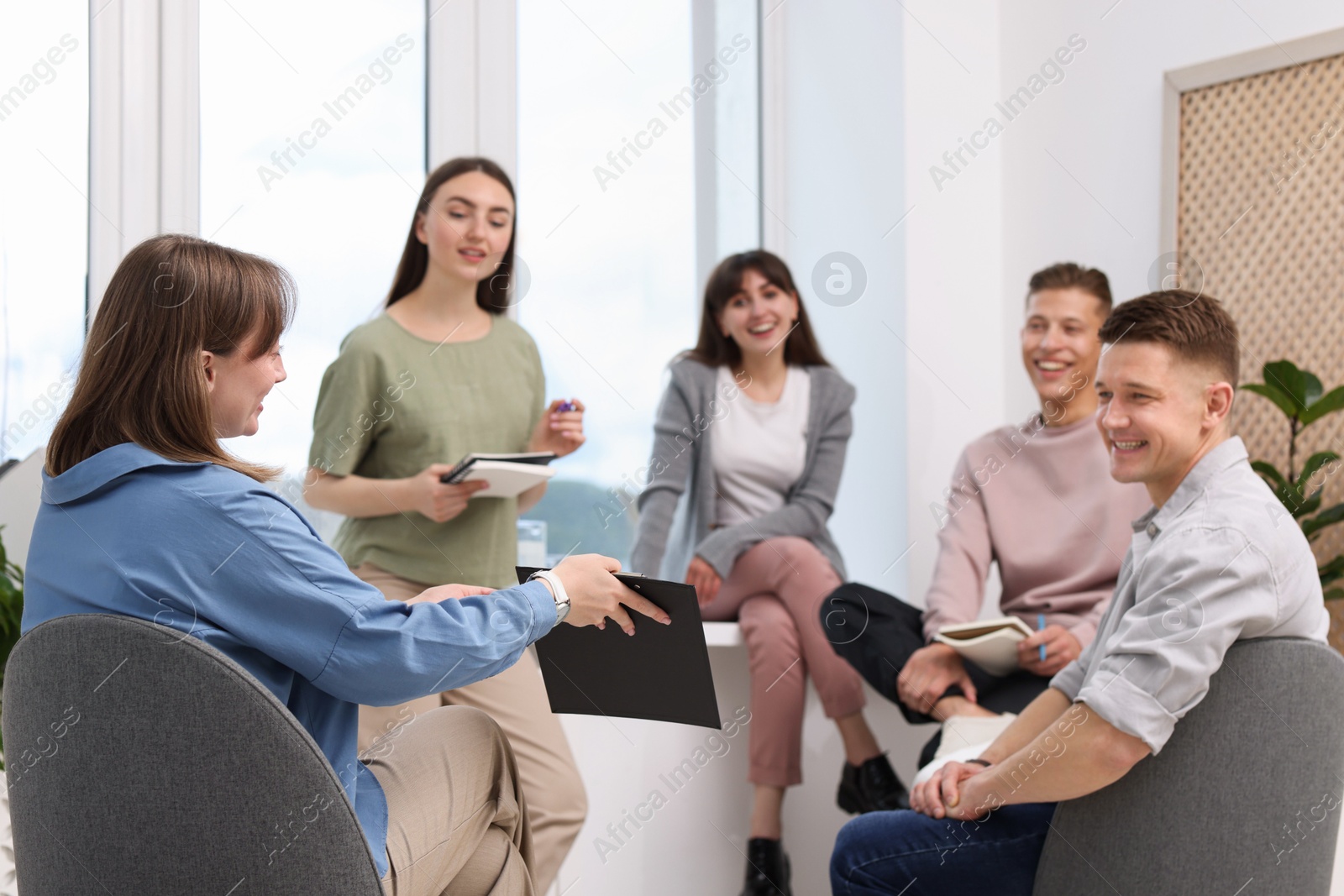 Photo of Group of people having meeting during life coaching class indoors