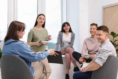 Photo of Group of people having meeting during life coaching class indoors
