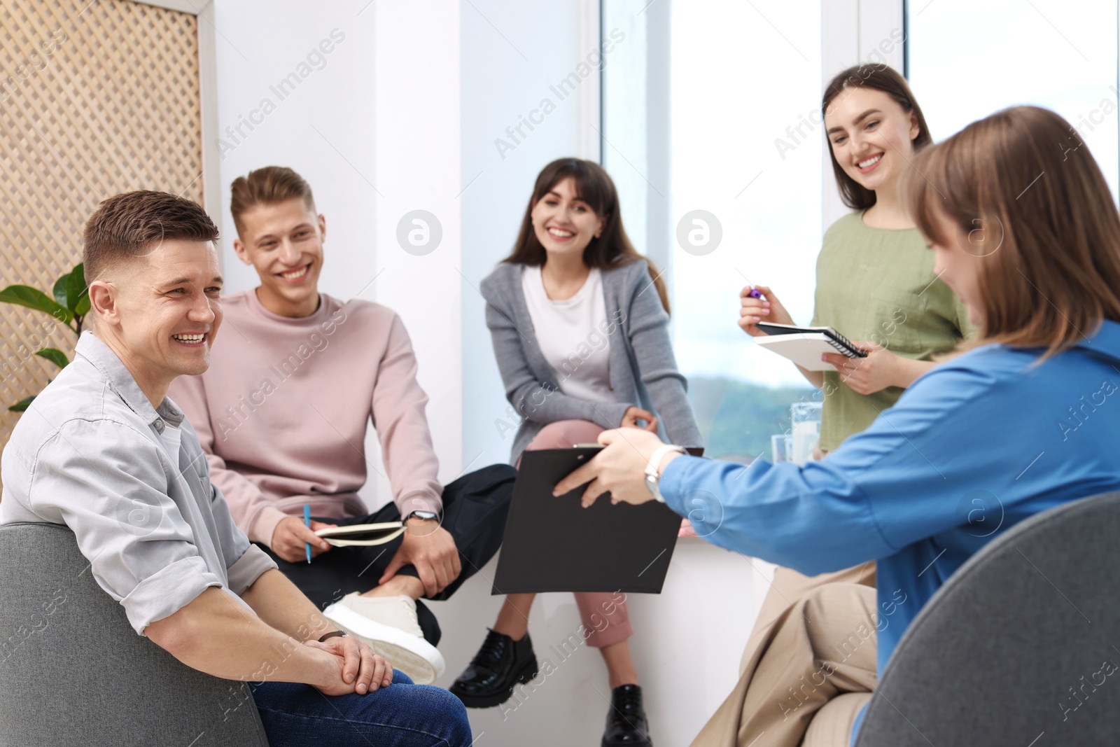 Photo of Group of people having meeting during life coaching class indoors