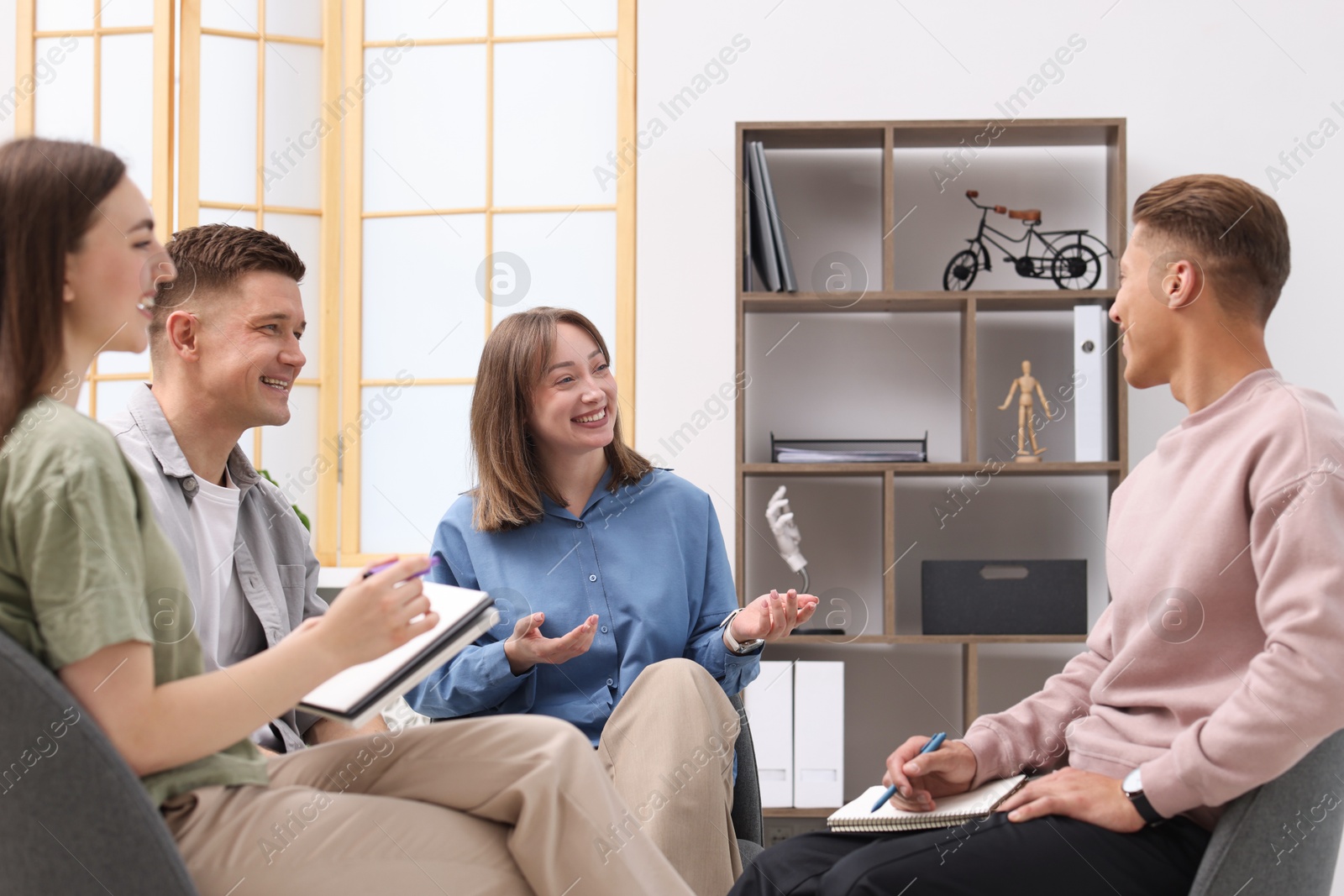 Photo of Group of people having meeting during life coaching class indoors