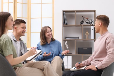 Photo of Group of people having meeting during life coaching class indoors