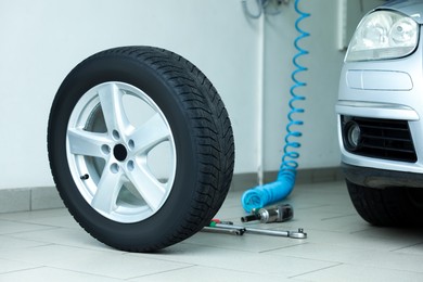 Photo of New tire and tools at car service