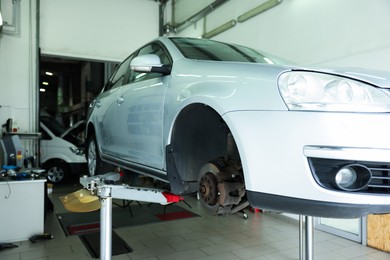 Photo of Lifted automobile during tire change at car service