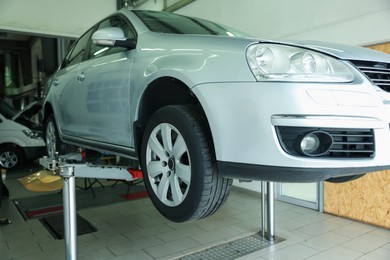 Photo of Lifted automobile during tire change at car service
