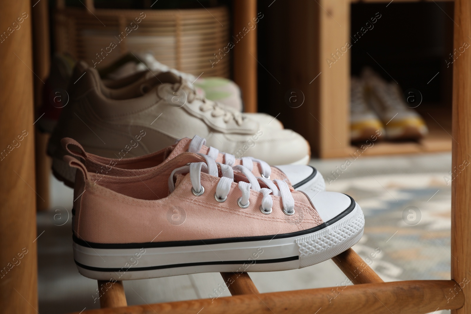 Different footwear on bench indoors. Shoe storage Photo of Different footwear on bench indoors. Shoe storage