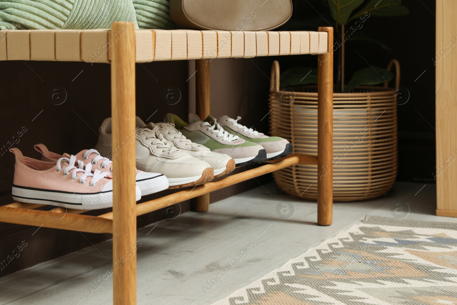 Different footwear on bench indoors. Shoe storage Photo of Different footwear on bench indoors. Shoe storage