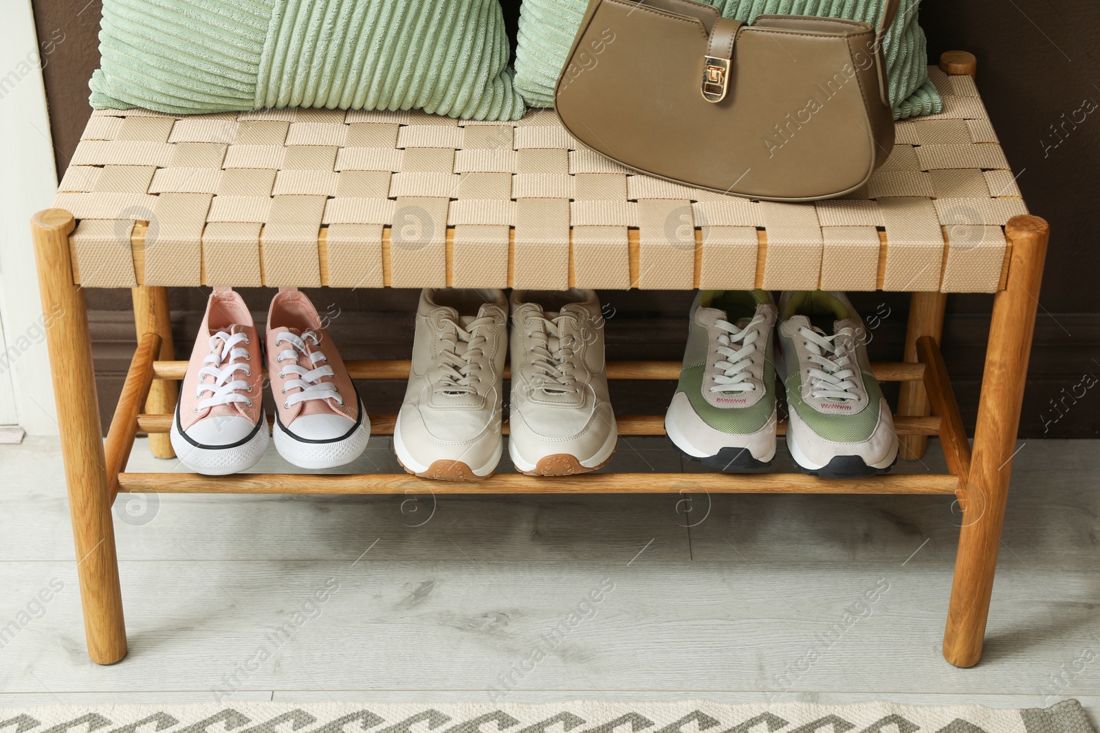 Different footwear on bench indoors. Shoe storage Photo of Different footwear on bench indoors. Shoe storage