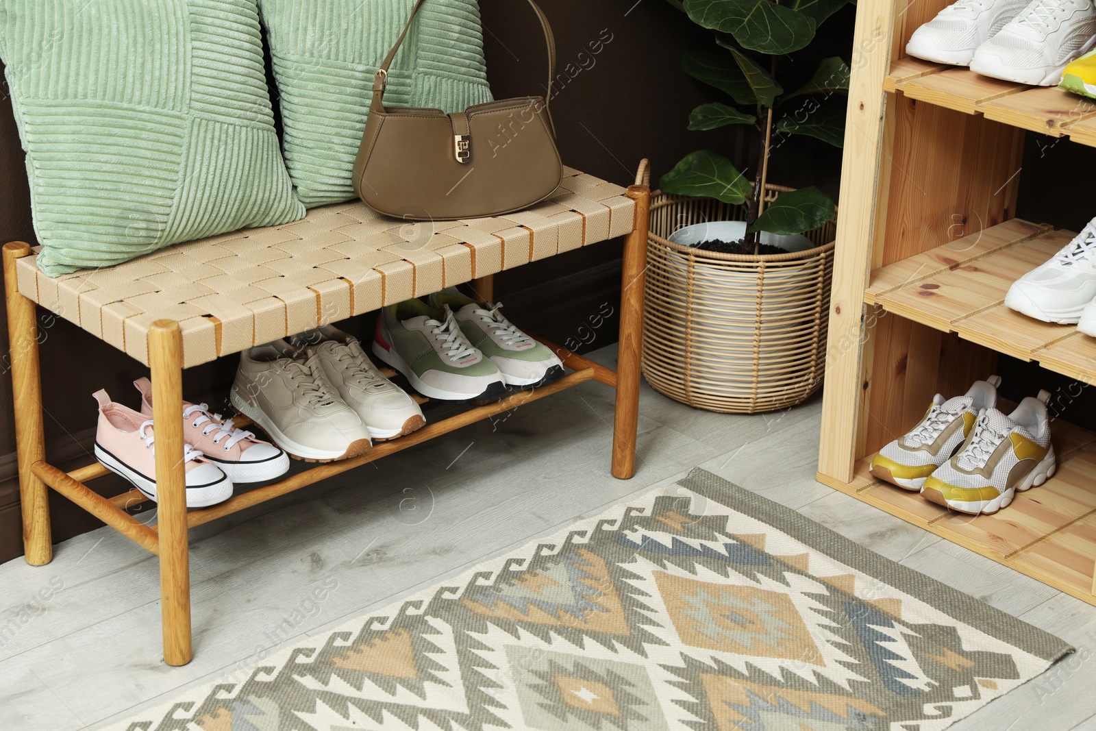 Different footwear on shelves in entryway. Shoe storage Photo of Different footwear on shelves in entryway. Shoe storage