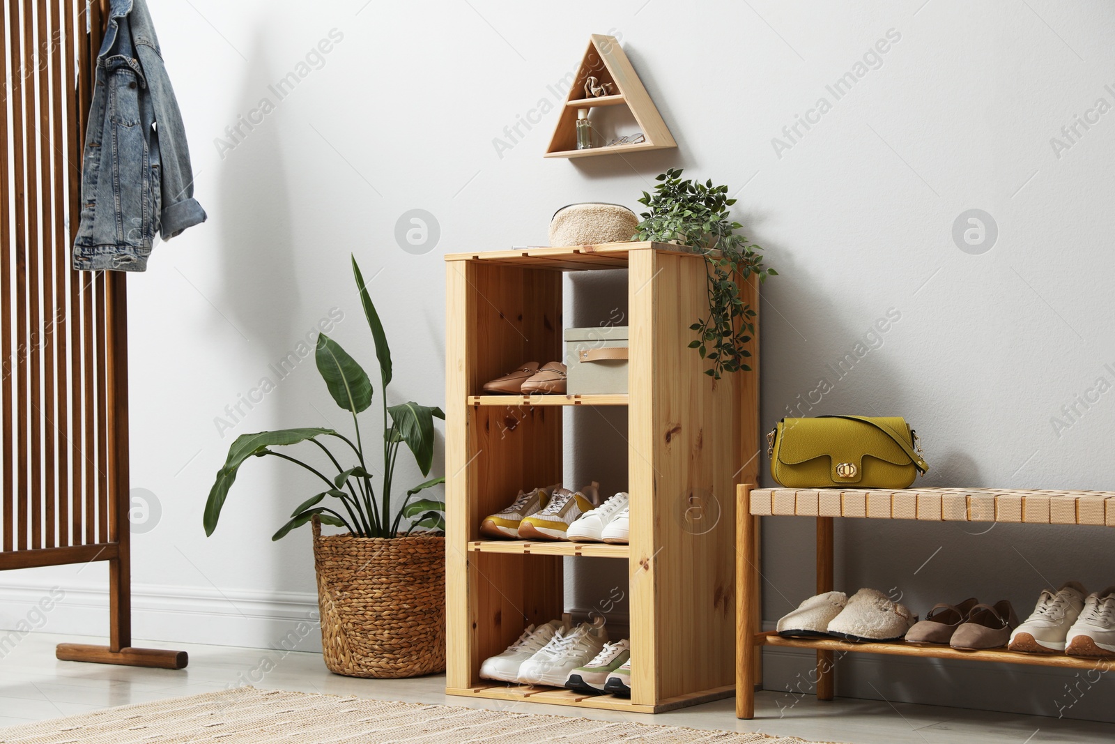 Different footwear on shelves in entryway. Shoe storage Photo of Different footwear on shelves in entryway. Shoe storage