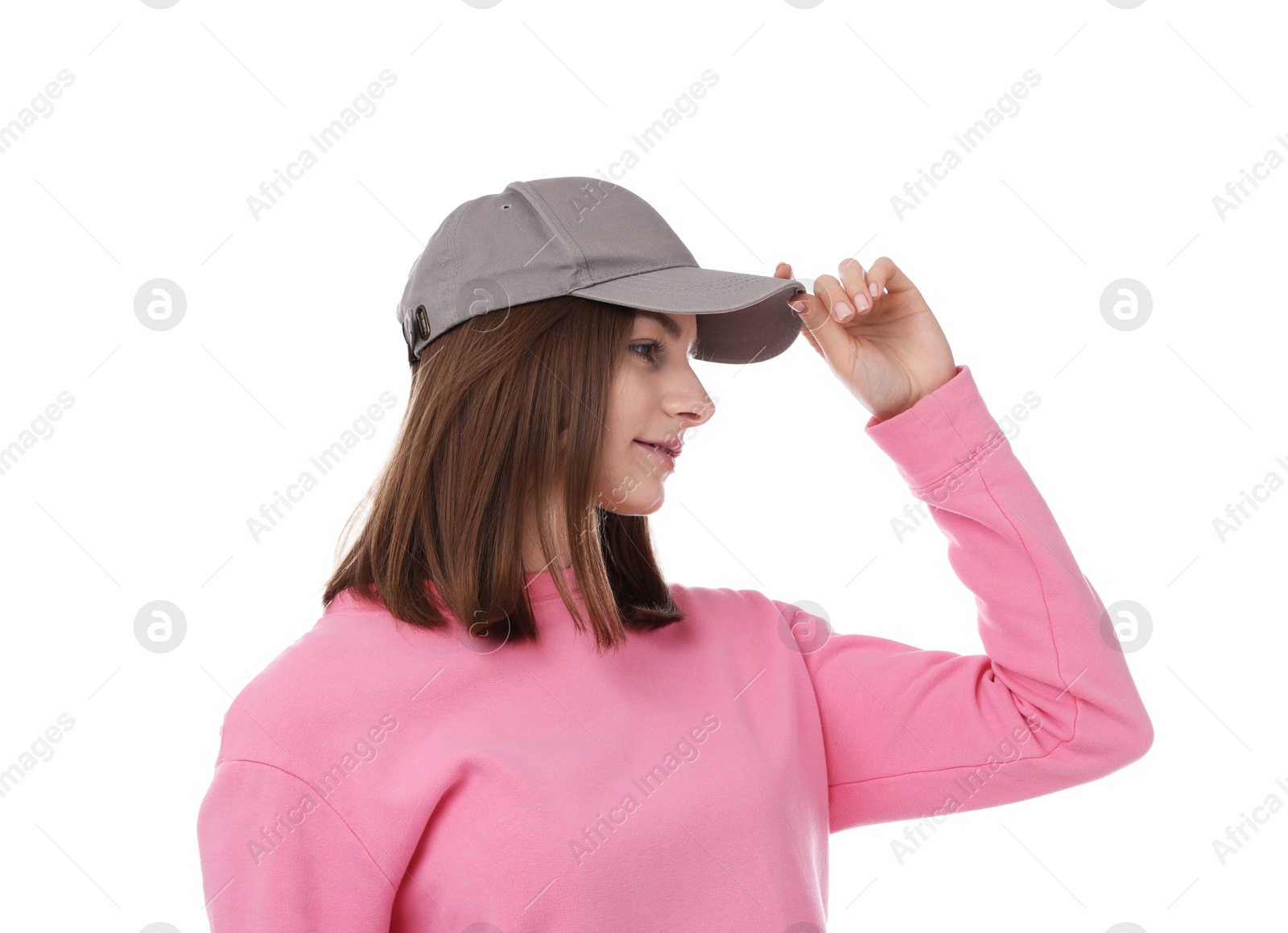 Young woman wearing stylish grey baseball hat on white background Photo of Young woman wearing stylish grey baseball hat on white background