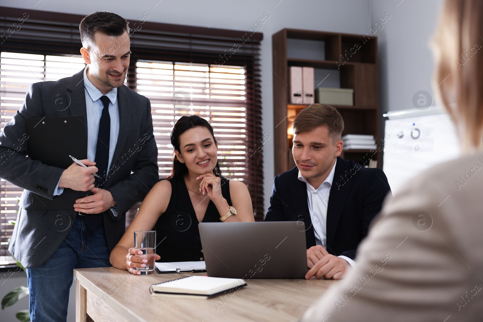 Photo of Marketing. Team of businesspeople working together at desk in office
