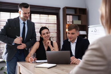 Photo of Marketing. Team of businesspeople working together at desk in office