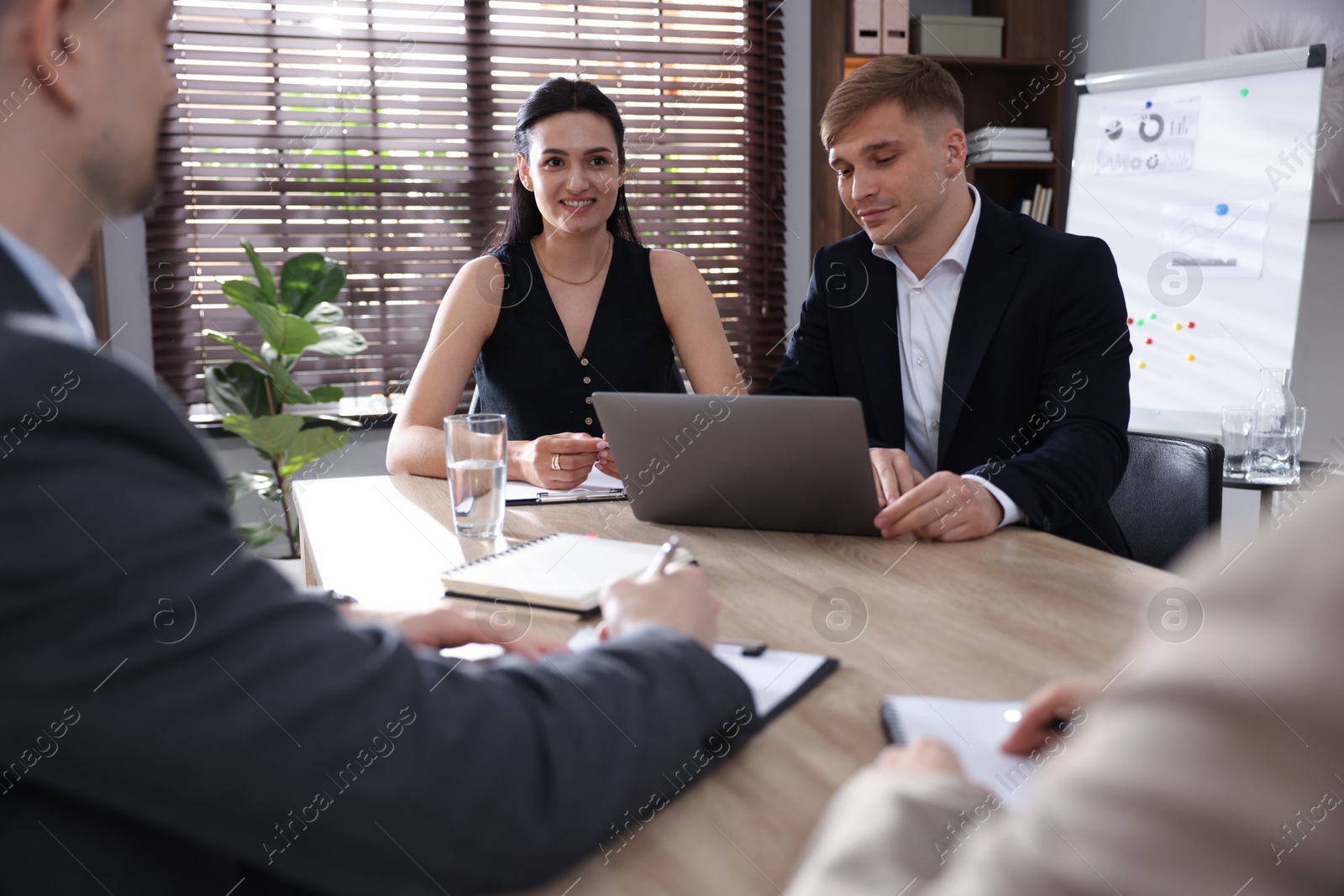 Photo of Marketing. Team of businesspeople working together at desk in office