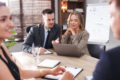 Photo of Marketing. Team of businesspeople working together at desk in office