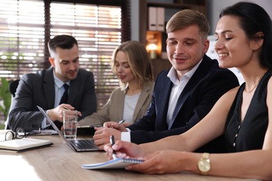 Photo of Marketing. Team of businesspeople working together at desk in office