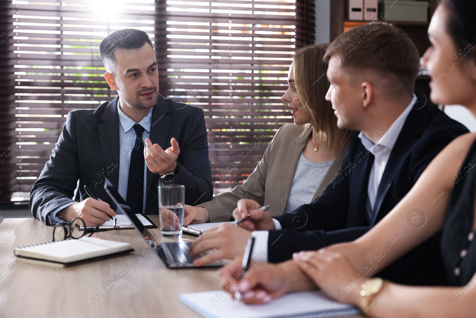 Photo of Marketing. Team of businesspeople working together at desk in office