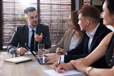 Photo of Marketing. Team of businesspeople working together at desk in office