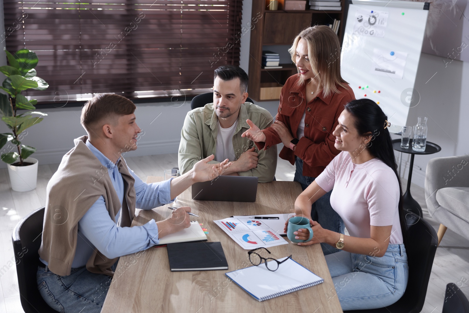 Photo of Marketing. Team of businesspeople working together at desk in office