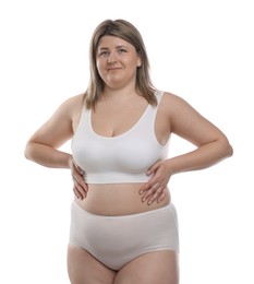 Photo of Weight loss. Plus size woman in underwear on white background