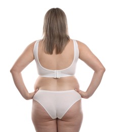 Photo of Weight loss. Plus size woman in underwear on white background, back view