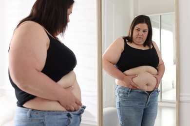 Photo of Woman with excessive belly fat near mirror indoors. Overweight problem