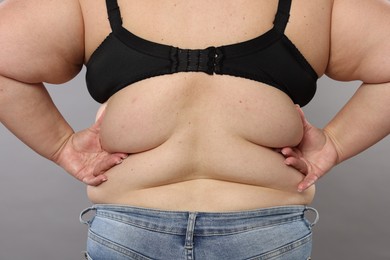 Photo of Overweight woman on grey background, back view