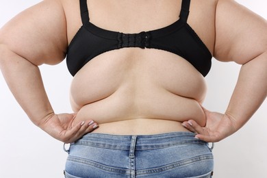 Photo of Overweight woman on white background, back view