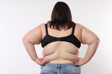 Photo of Overweight woman on white background, back view