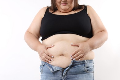 Photo of Woman with excessive belly fat on white background, closeup
