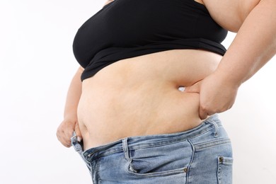 Photo of Woman with excessive belly fat on white background, closeup