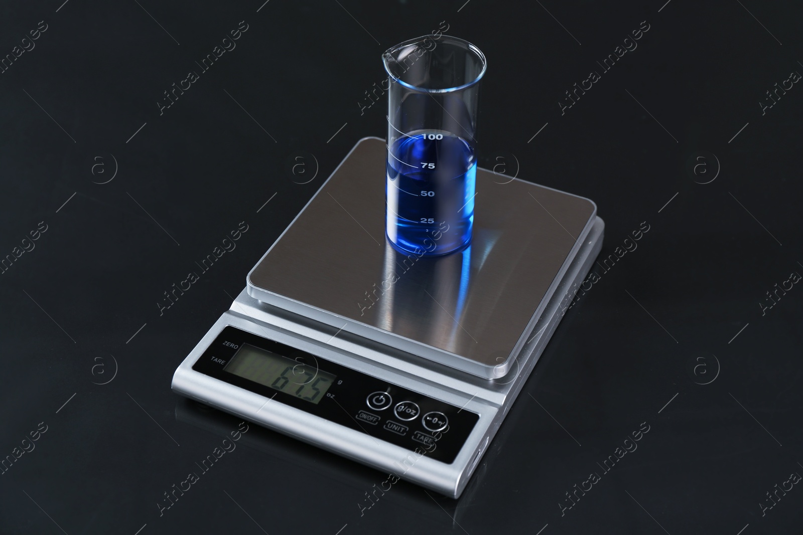 Scale with beaker of sample on black mirror table, closeup Photo of Scale with beaker of sample on black mirror table, closeup