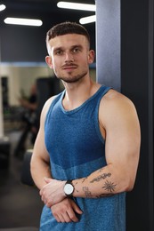 Photo of Portrait of professional personal trainer in gym