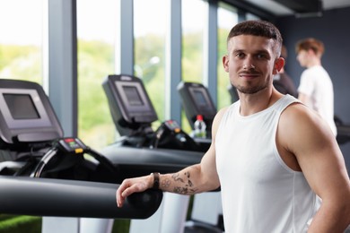Photo of Portrait of professional personal trainer in sport center