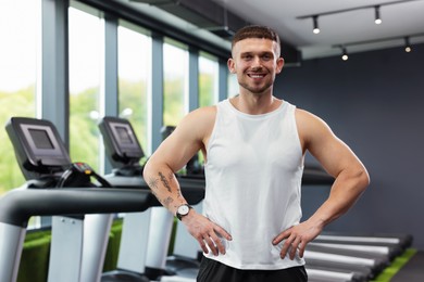 Photo of Portrait of professional personal trainer in sport center
