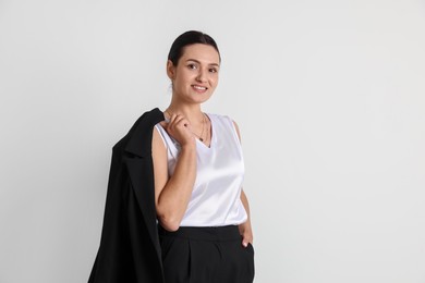 Photo of Confident business woman in suit on light background