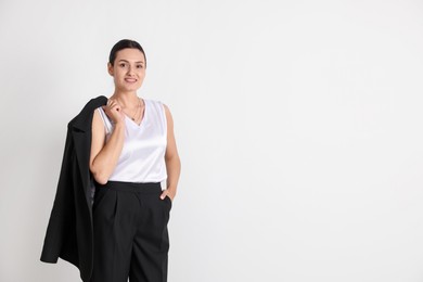 Photo of Confident business woman in suit on light background. Space for text