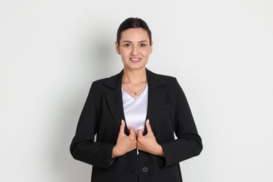 Photo of Confident business woman in suit on light background