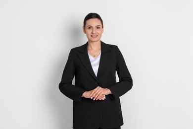 Photo of Confident business woman in suit on light background