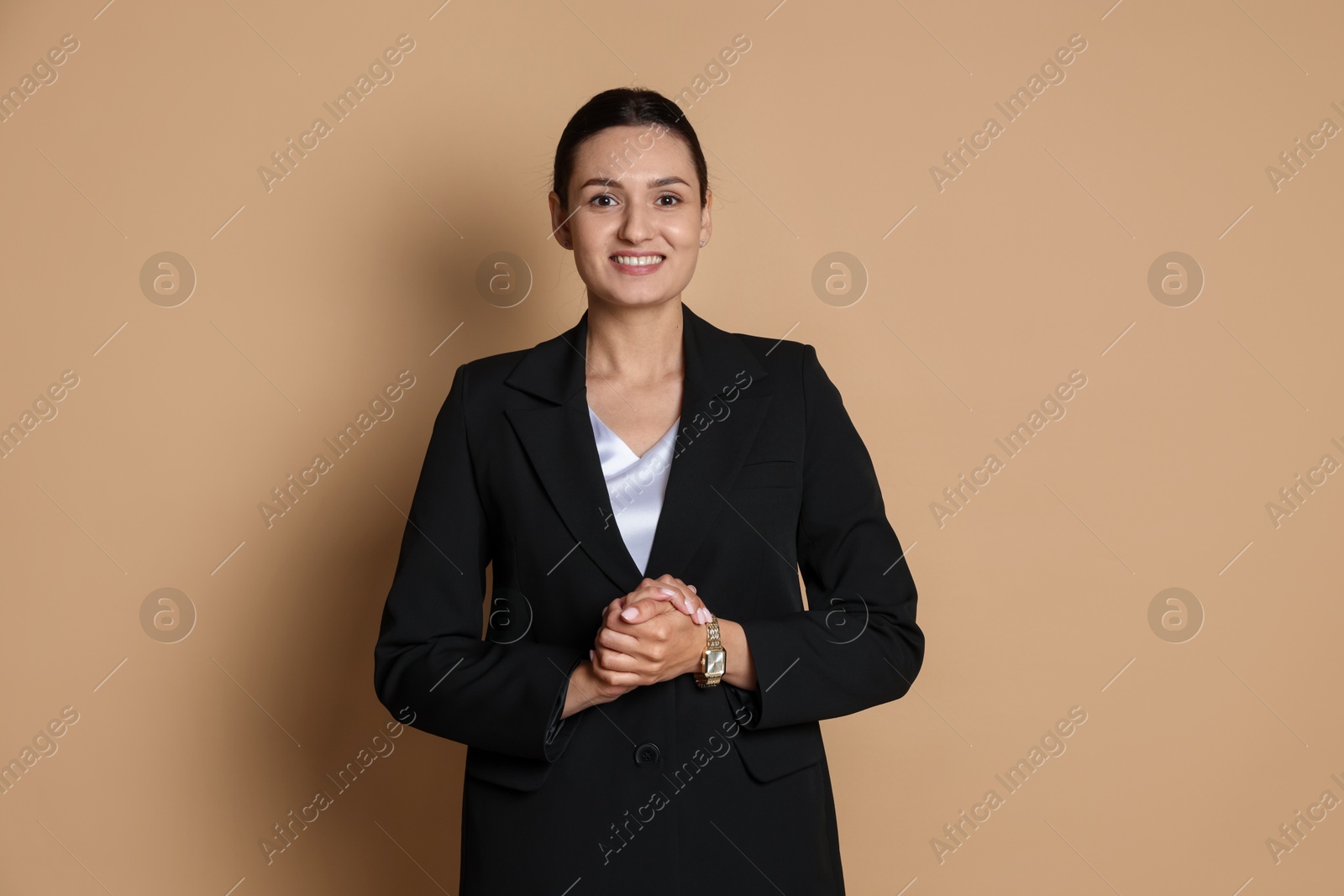 Photo of Confident business woman in suit on beige background