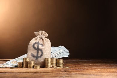 Photo of Bag, dollar banknotes and stacked coins on wooden table against beige gradient background, space for text