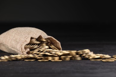Photo of Bag and coins on dark background, closeup