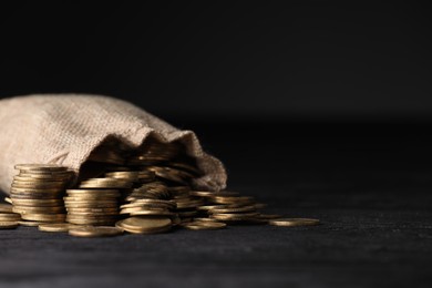 Photo of Bag and coins on dark background, closeup. Space for text