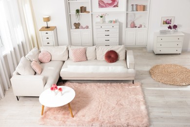 Photo of Cozy living room interior. Side table, sofa and shelving unit indoors, above view