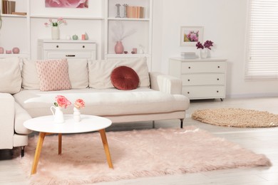 Photo of Cozy living room interior. Side table, sofa and dresser indoors