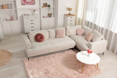 Photo of Cozy living room interior. Side table, sofa and shelving unit indoors, above view