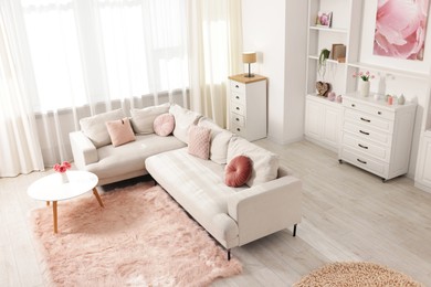 Photo of Cozy living room interior. Side table, sofa and shelving unit indoors, above view